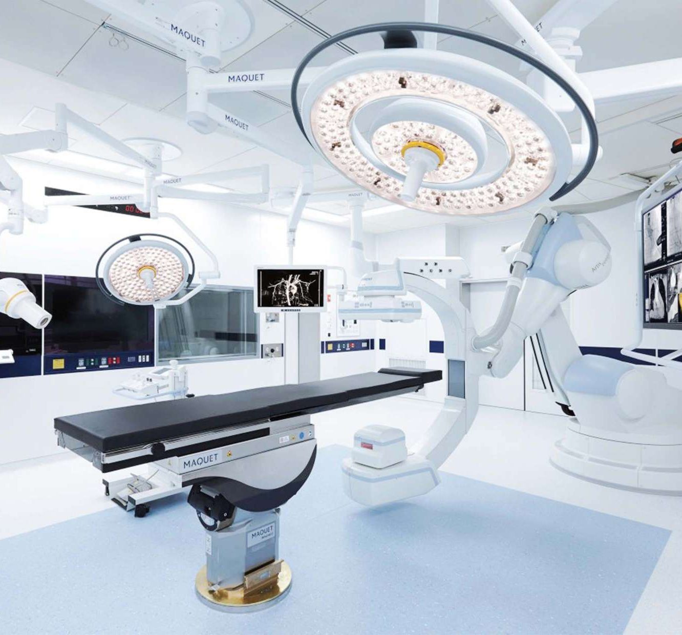 A modular operating room with a ceiling-mounted surgical light and imaging equipment