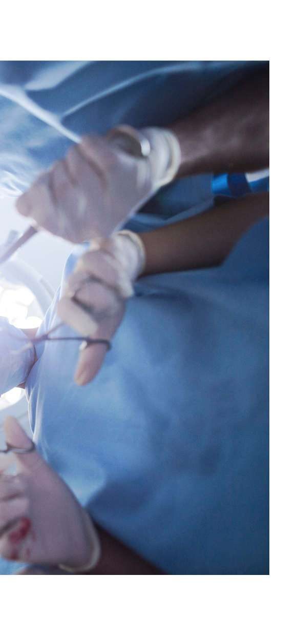 A surgeon in a mask and cap